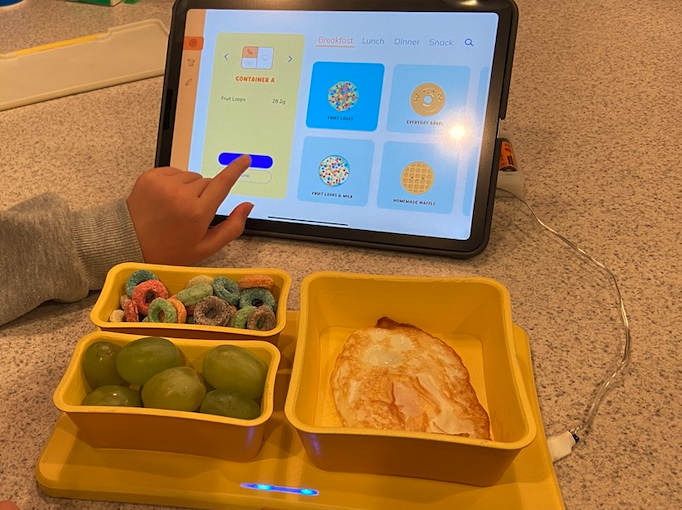 An Equilibrium user selects their food portion on a tablet screen.